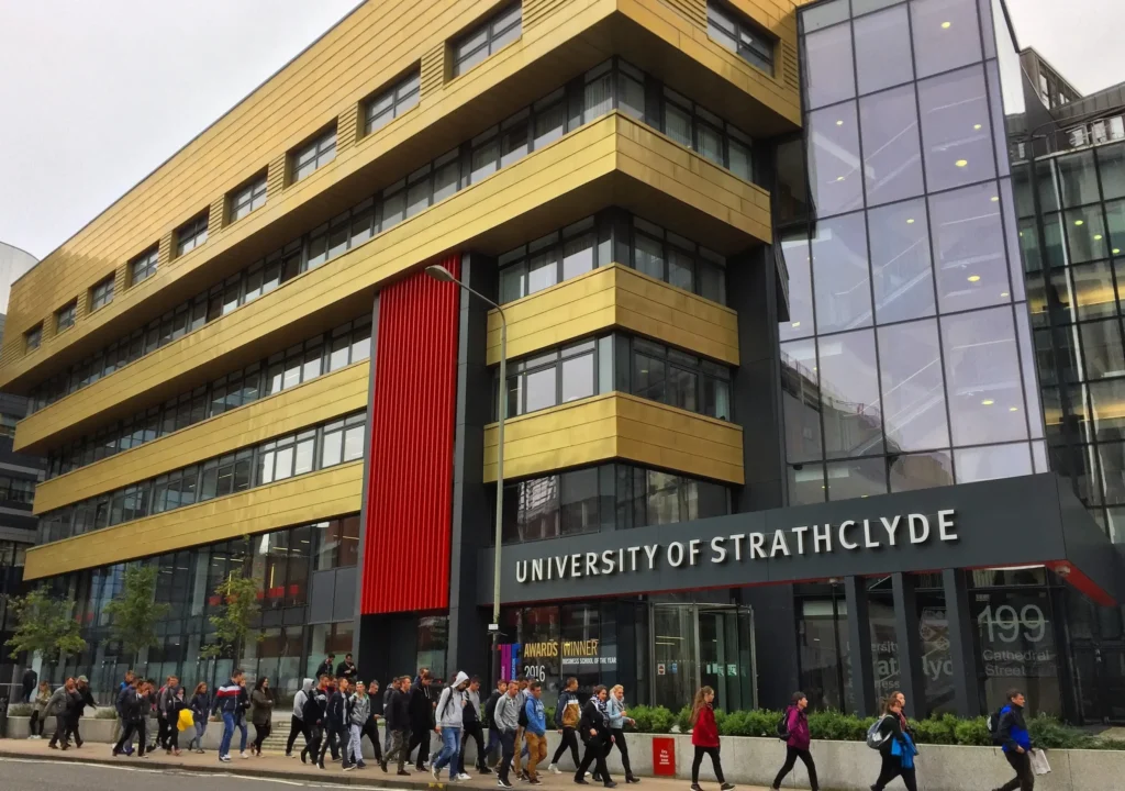 People walking by the University of St George's building near Strathclyde Business School.