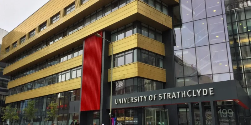 People walking by the University of St George's building near Strathclyde Business School.